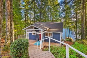 a tiny house in the woods with a deck at Lakefront retreat with view deck & private dock in Shelton +28 photos