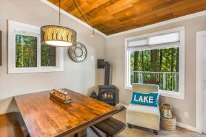 a dining room with a table and a chair and a fireplace at Lakefront retreat with view deck & private dock in Shelton