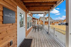 a wooden deck with a table and chairs on it at Comfy & close to Lake Pend Oreille & Schweitzer in Dover