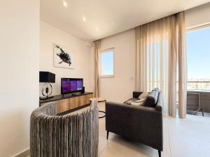 a living room with a couch and a television at St Julians - Spinola Space by DNA in St. Julianʼs