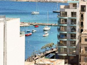 a view of a harbor with boats in the water at St Julians - Spinola Space by DNA in St. Julianʼs