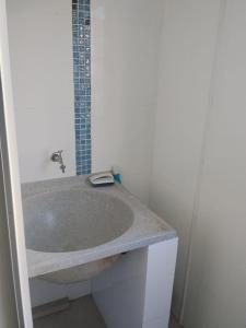 a bathroom with a sink and a shower at Apê Boa Vista in Vila Velha