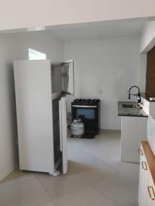 a kitchen with a refrigerator and a stove at Apê Boa Vista in Vila Velha +6 photos