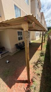 a wooden pergola in front of a building at Apt 102 in Parnamirim +3 photos