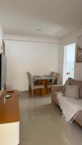a living room with a couch and a table at Apt 102 in Parnamirim