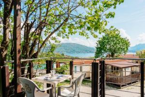 a table and chairs on a balcony with a view of a lake at Campeggio Tranquilla in Baveno