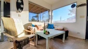 a living room with a couch and a table and chairs at YellowStone in Balneario Buenos Aires
