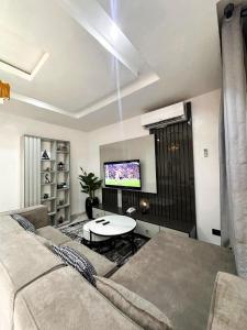 a living room with a couch and a table at Supreme Apartments in Ibadan +2 photos