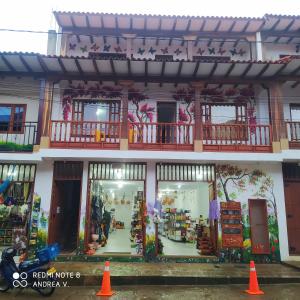 a store front with orange cones in front of it at Hotel La Terraza Raquireña in Ráquira