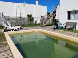a pool of water with a chair and a table at YellowStone in Balneario Buenos Aires