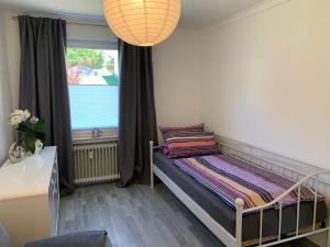 a small bedroom with a bed and a window at Ferienidylle im Westerwald in Seck