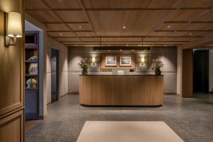 a lobby with a reception desk in a building at Hotel Auenhof in Lech am Arlberg