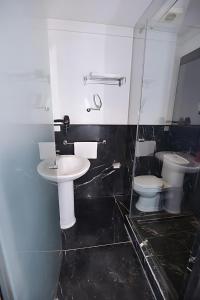 a bathroom with two toilets and a sink at Le 135 appart hotel in Casablanca +21 photos
