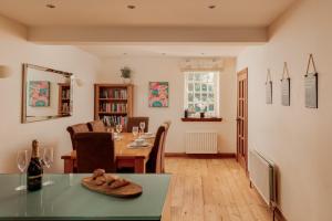 a living room with a table and a dining room at Puffin Cottage, Bamburgh in Bamburgh