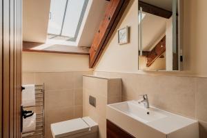a bathroom with a sink and a toilet at Puffin Cottage, Bamburgh in Bamburgh +45 photos