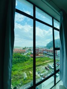 a window with a view of a city at GR studio APARTMENT 1 - kompleks MUTIARA gua MUSANG in Gua Musang