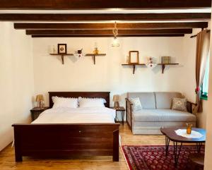 a bedroom with a bed and a couch at Selsko domacinstvo Nevena in Kumanovo