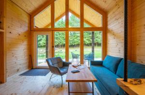 a living room with a blue couch and a table at Chata a Chalety Starý mlyn in Veľká Franková