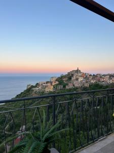 a view of the ocean from the balcony of a house at Domus Mea, Case Vacanza Vista Mare vicino Taormina in Forza dʼAgro