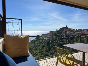 a balcony with a table and chairs and a view at Domus Mea, Case Vacanza Vista Mare vicino Taormina in Forza dʼAgro
