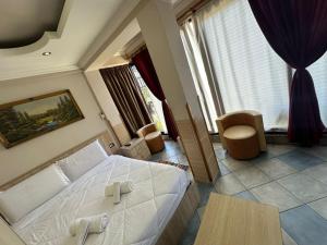 a bedroom with a white bed in a room at Hotel Ideal in Shkodër +26 photos