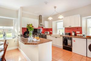 a kitchen with white cabinets and a counter top at 3 Bed in Kirriemuir oc-96450 in Kirriemuir