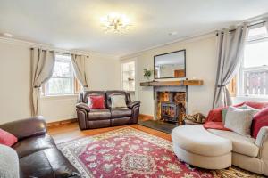 a living room with leather furniture and a fireplace at 3 Bed in Kirriemuir oc-96450 in Kirriemuir