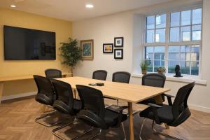 a conference room with a wooden table and black chairs at City Studios, Preston in Preston