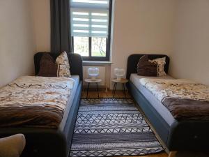 two beds sitting in a room with a window at FEWO Civrilli 1 Zeitz in Zeitz