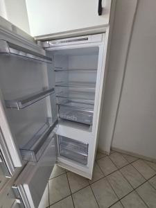 an empty refrigerator with its door open in a kitchen at FEWO Civrilli 1 Zeitz in Zeitz