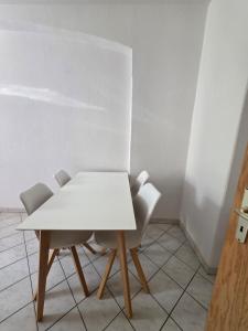 a white table and chairs in a room at FEWO Civrilli 1 Zeitz in Zeitz