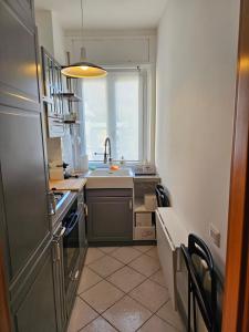 a small kitchen with a sink and a window at Apartment with a Mountain View in Lecco
