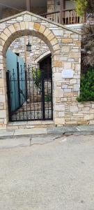 an entrance to a building with an iron gate at A&Bpikermistudios in Pikérmion