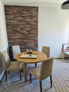 a table and chairs in a room with a brick wall at Apartment with a Mountain View in Lecco +5 photos