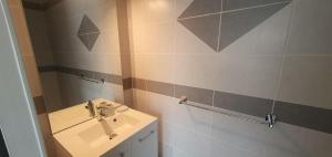 a bathroom with a sink and a mirror at Maison familiale Montardon in Montardon +21 photos
