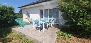 a blue table and chairs on a patio at Maison familiale Montardon in Montardon