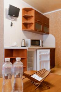 two water bottles sitting on a table in a kitchen at Санаторій Сонячний in Verbki