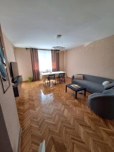 a living room with a couch and a table at Golubac Bay Apartment in Golubac