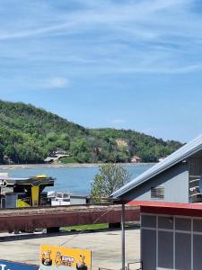 a view of a river with a boat on a dock at Golubac Bay Apartment in Golubac