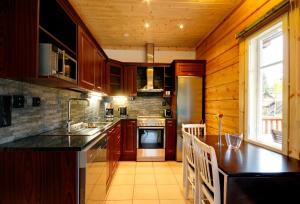a kitchen with wooden cabinets and a counter top at Puttitie 4B in Tahkovuori