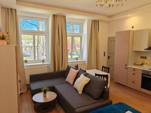 a living room with a couch and a table at Apartmány Promenáda in Trutnov