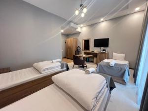 a hospital room with two beds and a desk at Baza Hotel Spa in Beylǝqan