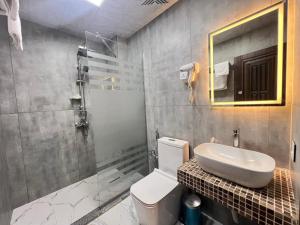 a bathroom with a toilet and a sink and a mirror at Baza Hotel Spa in Beylǝqan +39 photos