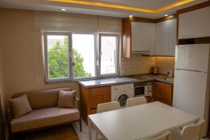 a kitchen with a couch and a table in a kitchen at Ada Apart Hotel in Antalya