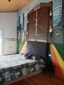 a bed in a room with a mural on the wall at Apartamento Jurásico in Barreiros +3 photos