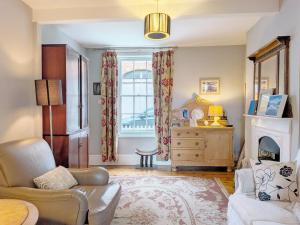 a living room with a couch and a fireplace at Gainsford - Arundel in Arundel
