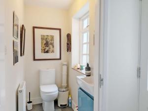 a bathroom with a toilet and a sink at Gainsford - Arundel in Arundel +16 photos