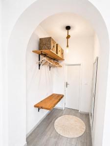 a hallway with a wooden bench on the wall at Refúgio do Bugalho - Casa da Oliveira in Alandroal