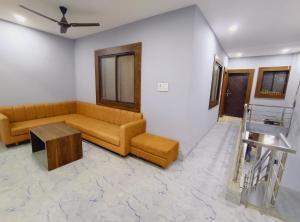 a living room with a couch and a table at shree krishna Hotel in Ujjain