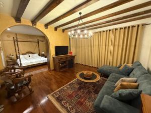 a living room with a couch and a bed at Mikpritja Korçë in Korçë